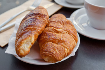 Breakfast with coffee and croissants