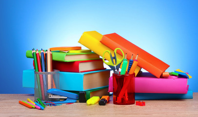 bright stationery and books on blue background