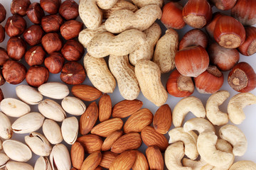 Obraz premium nutmeg, peanuts, hazelnuts and almonds on wooden background
