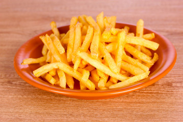 French fries on wooden background