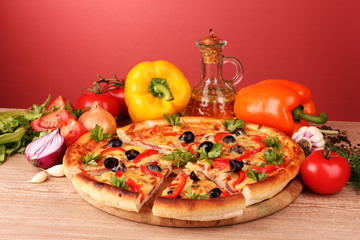 pizza and vegetables on a red background