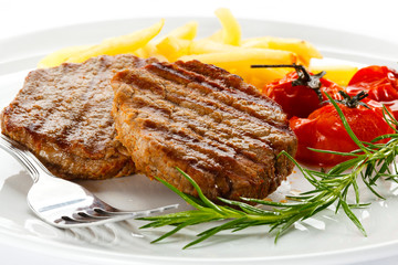 Grilled steak, French fries and vegetables