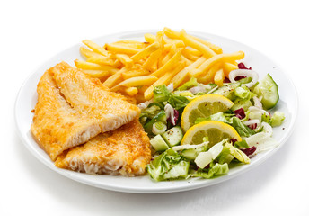 Fish dish - fried fish fillet, French fries with vegetables