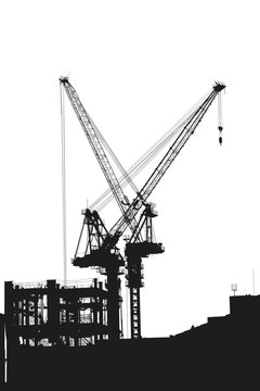Silhouettes of two elevating cranes on background of building