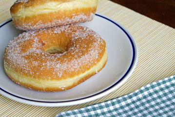 Obraz na płótnie Canvas two donuts with sugar