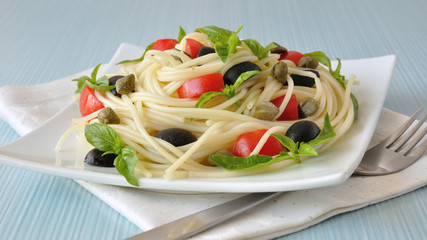Spaghetti with tomato, capers and basil with olives
