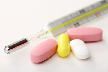 Medical thermometer and pills.