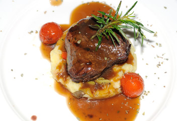 Meat main course served with mashed potato and vegetables