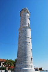 White lighthouse on Murano island in a sunny day, Venice, Italy