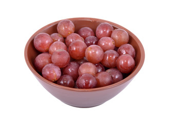 Red Grapes in a bowl, isolated on a white background