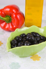 Plate with olives on the table