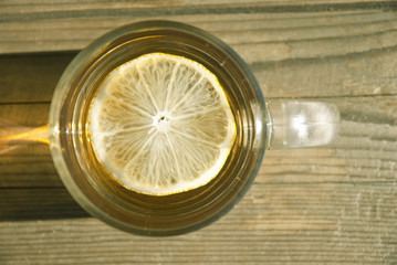 cup of tea with lemon on wooden table, top view
