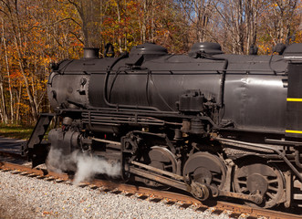 Naklejka premium Steam train powers along railway