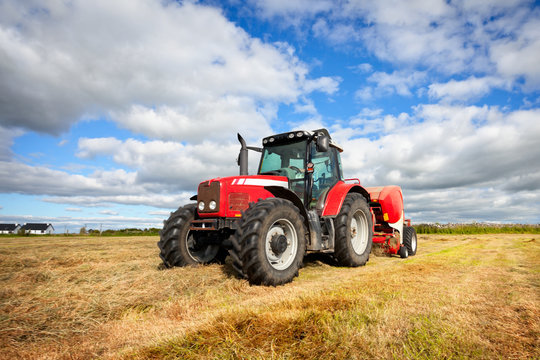 tractor collecting haystack in the field, panning technique