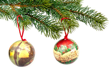 Christmas balls with decoration on a green spruce branch