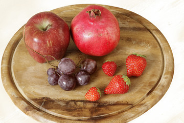 red fruits on  chopping board