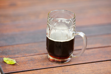 mug with dark beer standing on the table