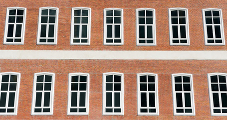 Windows on red brick wall