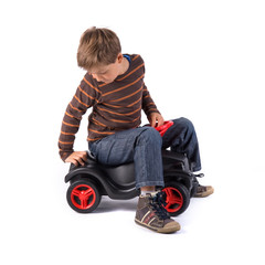 young little boy playing with his car