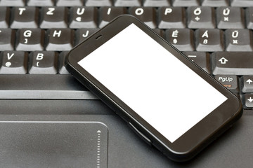 smartphone on a laptop - business concept