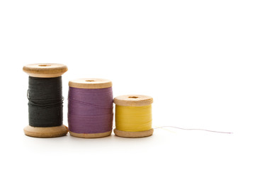 Thread bobbins on the white background