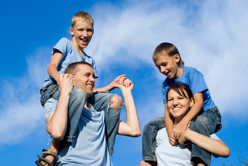 family posing at sky