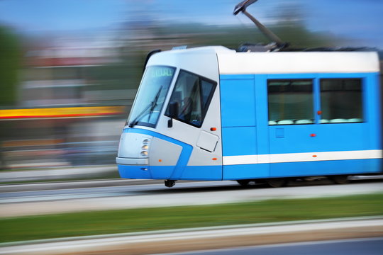 Modern  blue tram rider fast on rails, Wroclaw, Poland
