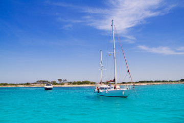 anchored sailboats in turquoise Formentera beach