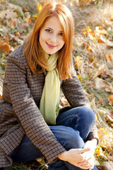 Obraz premium Portrait of red-haired girl in the autumn park