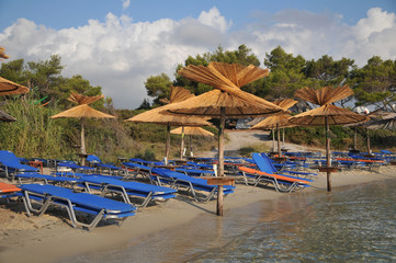 sandy beach with umbrellas and  loungers