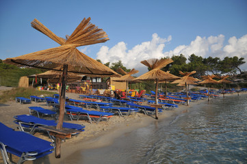 sandy beach with umbrellas and  loungers