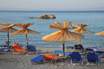 sandy beach with umbrellas and  loungers
