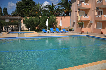 hotel with swimming pool and sun loungers