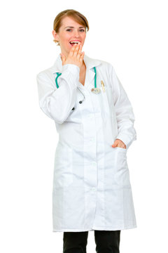 Medical doctor woman confusedly laughing