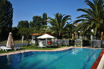hotel with swimming pool and sun loungers