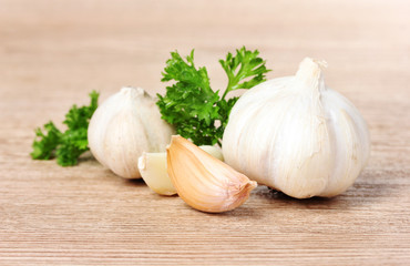 spices, garlic and parsley on a wooden background