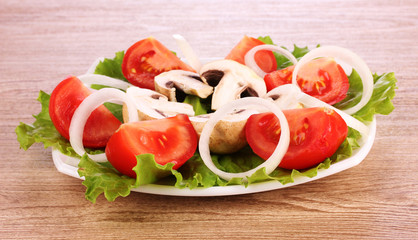 many vegetables on the plate on a wooden background