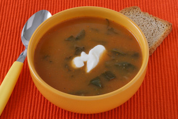 Spinach soup in yellow bowl