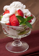 strawberries and kiwi on a table.