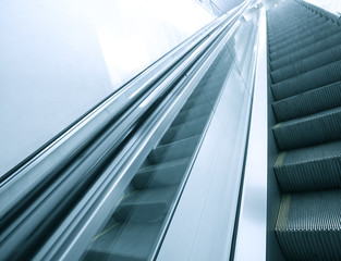 Obraz premium blue modern escalator in business center