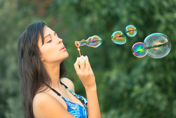 portrait of attractive young girl inflating colorful