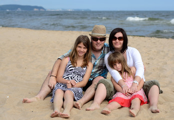 Happy family relaxing on the beach