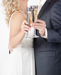 A glass of champagne in the hands of men and women