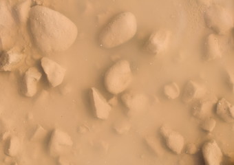 Steine im Schlamm unter Wasser