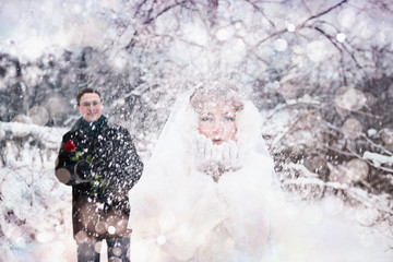 The bride is blowing the snow