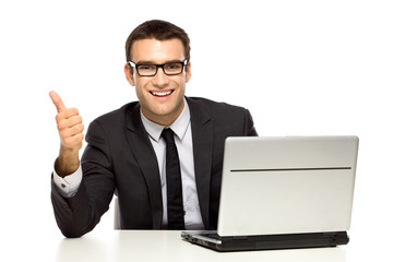 Businessman with laptop showing thumbs up
