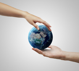 Male and female hand holding earth