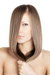Fototapeta premium young beautiful woman holding her beautiful long natural hair