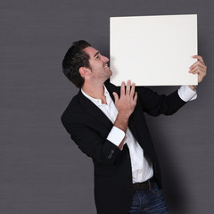 Funny salesman holding whiteboard