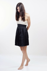 Arrested barefoot girl with arms crossed